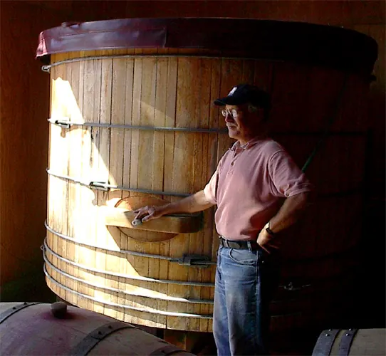 Randle Johnson beside a large wooden fermentation tank